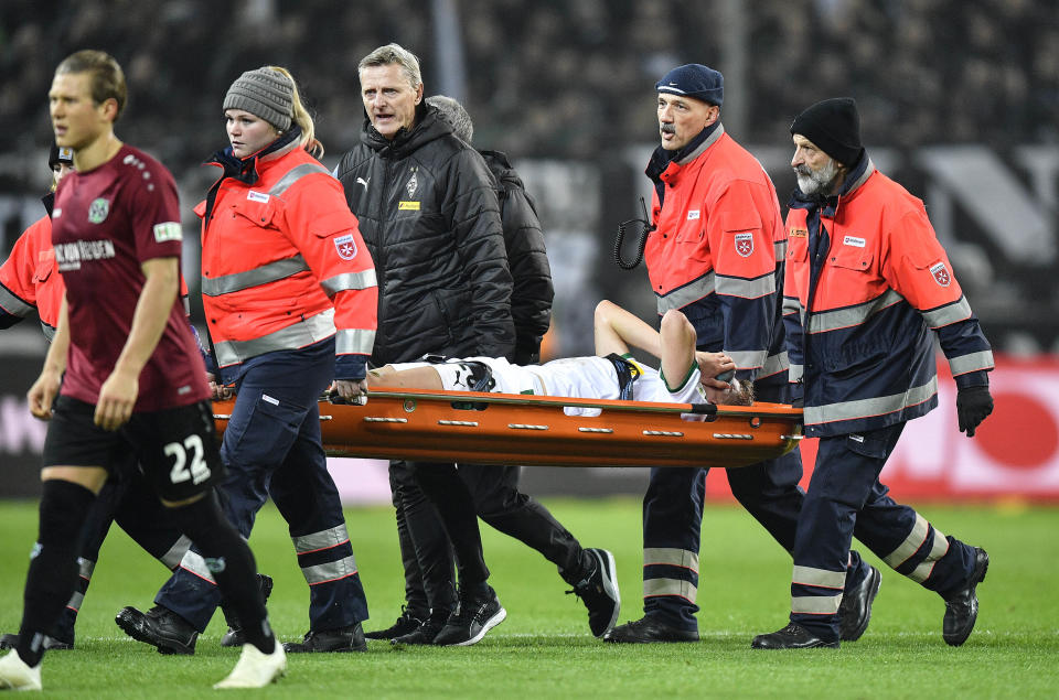 Moenchengladbach's Matthias Ginter is carried from the pitch injured during the German Bundesliga soccer match between Borussia Moenchengladbach and Hannover 96 at the Borussia Park in Moenchengladbach, Germany, Sunday, Nov. 25, 2018. (AP Photo/Martin Meissner)