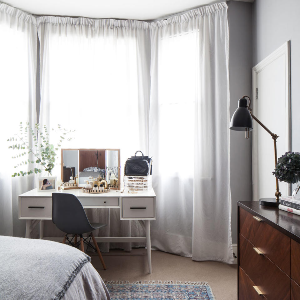 bedroom with white desk and curtains