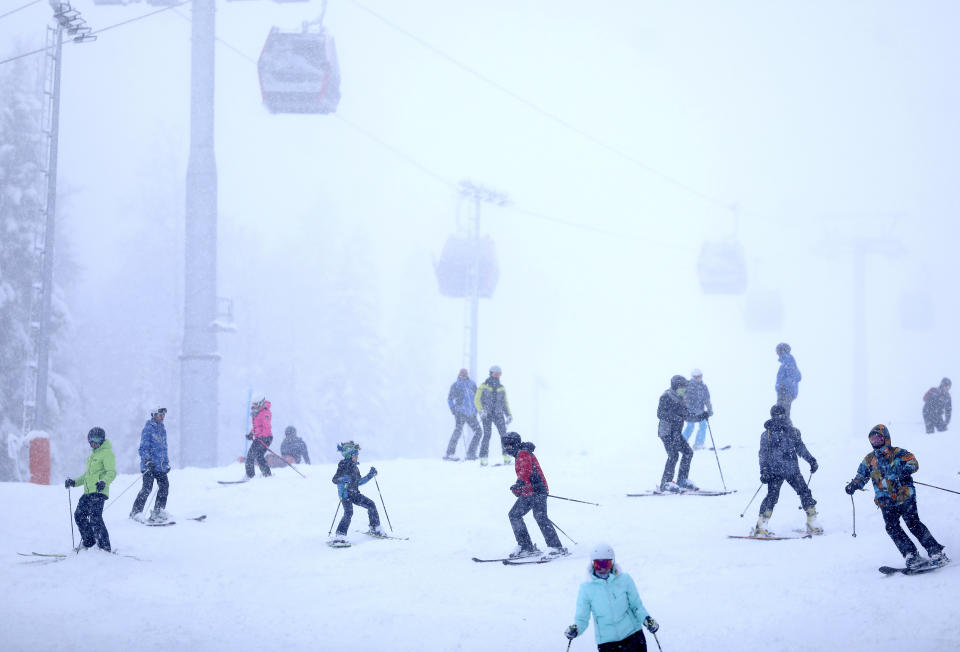 Skiers ski on the slopes of Mount Jahorina, 30 kilometers south of the Bosnian capital of Sarajevo, Saturday, Dec. 11, 2021. As most of Europe reintroduces measures to help curb the spread of the omicron variant, Bosnia, to the delight of its winter tourism industry, still maintains a relatively laissez-fair approach to the soaring COVID-19 infection numbers across the continent. (AP Photo/Marjan Vucetic)