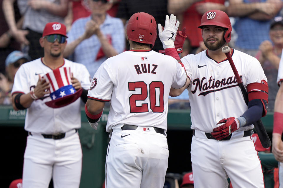 Washington Nationals' Keibert Ruiz (20) high-fives with Washington Nationals first baseman Juan Yepez, right, after hitting a three-run home run during the first inning of a baseball game against the St. Louis Cardinals at Nationals Park, Saturday, July 6, 2024, in Washington. (AP Photo/Mark Schiefelbein)