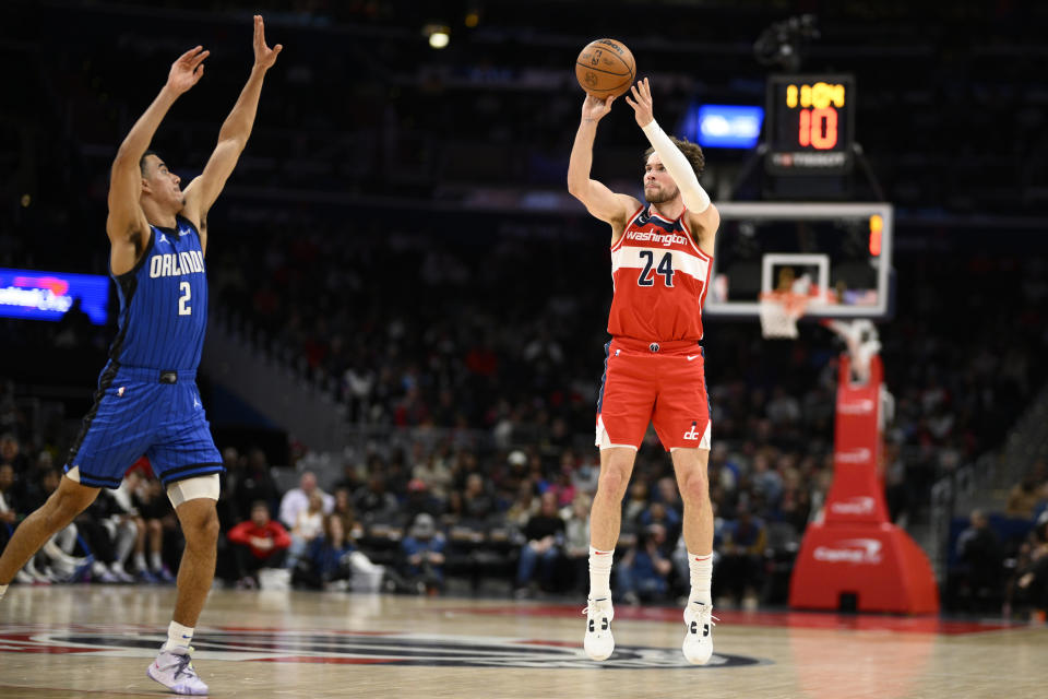 Washington Wizards forward Corey Kispert (24) shoots against Orlando Magic guard Caleb Houstan (2) during the first half of an NBA basketball game Friday, March 31, 2023, in Washington. (AP Photo/Nick Wass)