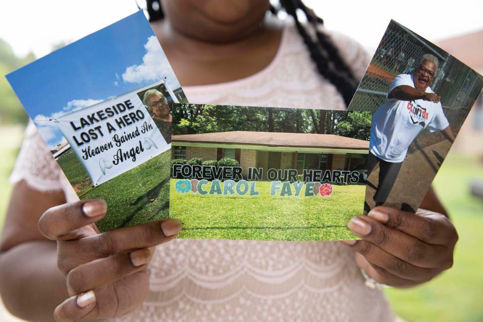 Shenika Jackson holds photos memorializing her late mother, Carol Faye Doby, who died from complications of COVID-19 earlier this year, in Bolton, Miss.