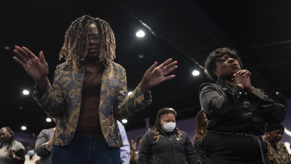 Maurene Bullock, left, and Dr. Angela Coprew-Boyd, pray during a prayer vigil held by the Chesapeake Coalition of Black Pastors at The Mount (Mount Lebanon Baptist Church) in Chesapeake, Va., Sunday, Nov. 27, 2022, for the six people killed at a Walmart in Chesapeake, Va., when a manager opened fire with a handgun before an employee meeting Tuesday night. (AP Photo/Carolyn Kaster)