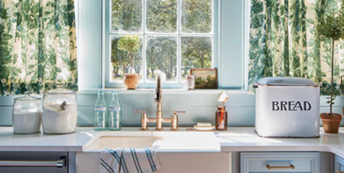 blue kitchen with green patterned cafe curtains