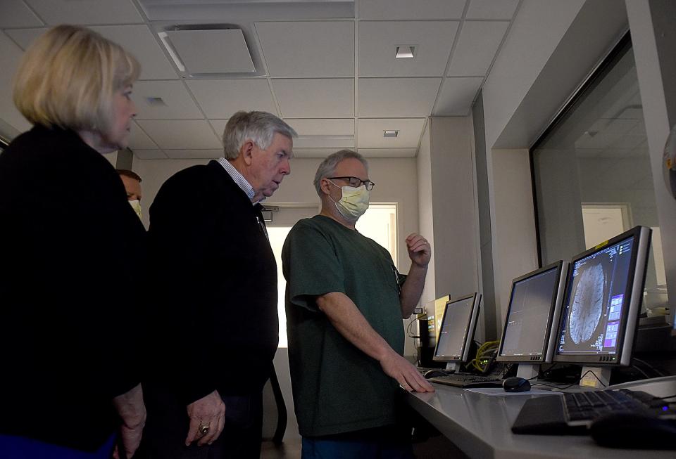 Mark Burton, right, a magnetic resonance imaging research technologist at the Roy Blunt NextGen Precision Health Institute, explains the details revealed in a brain scan to Gov. Mike Parson and his wife, Teresa, while operating a Magnetom Terra 7 Tesla MRI scanner on Friday.