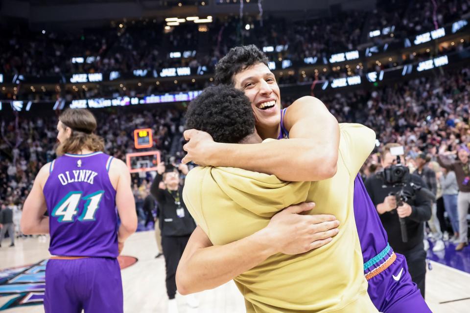 Utah Jazz guard Mike Conley hugs forward Simone Fontecchio after Fontecchio hit the game-winning dunk vs. Golden State.