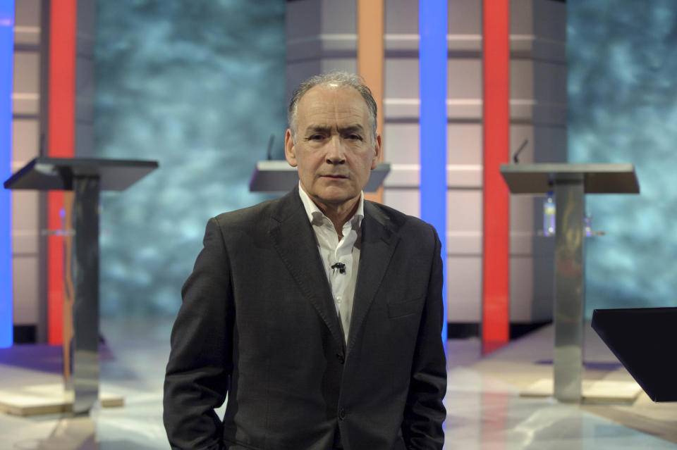 MANCHESTER, ENGLAND - APRIL 14:  In this handout image provided by ITV1, British journalist and newscaster Alastair Stewart looks on as the stage is prepared for the first televised general election debate between Gordon Brown, David Cameron and Nick Clegg for the United Kingdom's Prime Minister at ITV1 North West base studios on April 14, 2010 in Manchester, England. Britain for the first time is televising three political debates live, reminiscent of the U.S. style of debates. Alastair Stewart will moderate the first election debate, themed on domestic affair, airs April 15, 2010 live on ITV1 from 8.30 pm to 10.00 pm.   (Photo by Rob Evans/ITV via Getty Images)