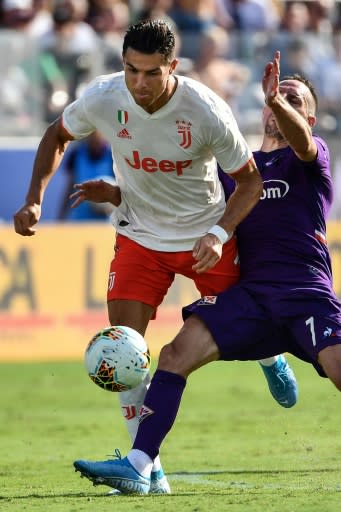 Fiorentina's French midfielder Franck Ribery (R) tackles Juventus star Cristiano Ronaldo