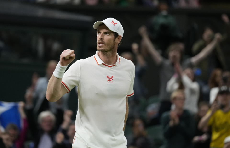 Britain's Andy Murray celebrates winning the men's singles match against Georgia's Nikoloz Basilashvili on day one of the Wimbledon Tennis Championships in London, Monday June 28, 2021. (AP Photo/Kirsty Wigglesworth)