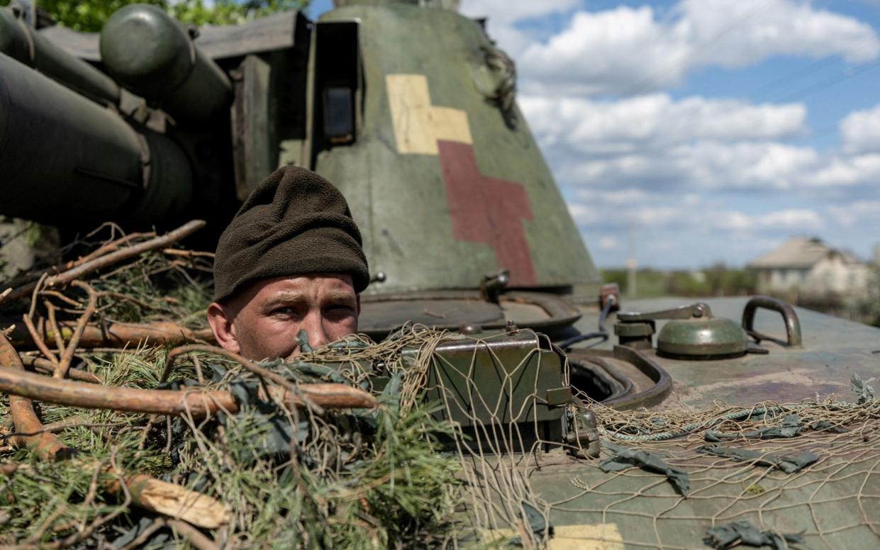 A Ukrainian soldier looks out from a tank in the city of Lyman - Jorge Silva/Reuters