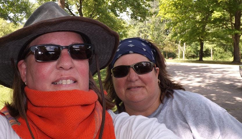 Amy Miller, left, and Paula Jo Southerland in a recent photo near their home in Kings Mills. Miller experienced an anxiety attack last year that drove her to spend five months living in a tent outdoors on her driveway. Her family finally persuaded her to get help in March, and she reports that she is recovering.