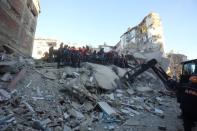 Rescuers work on a collapsed building after an earthquake in Elazig