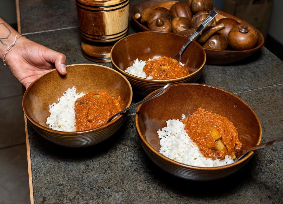 Milwaukee artist CK Ledesma serves up bowls of conbif, Puerto Rican corned beef hash, on June 23, 2023.  The dish, made with canned corned beef, tomato sauce, diced potatoes, plantains and sazon seasoning, was part of their 2020 project Proyecto Conbif.