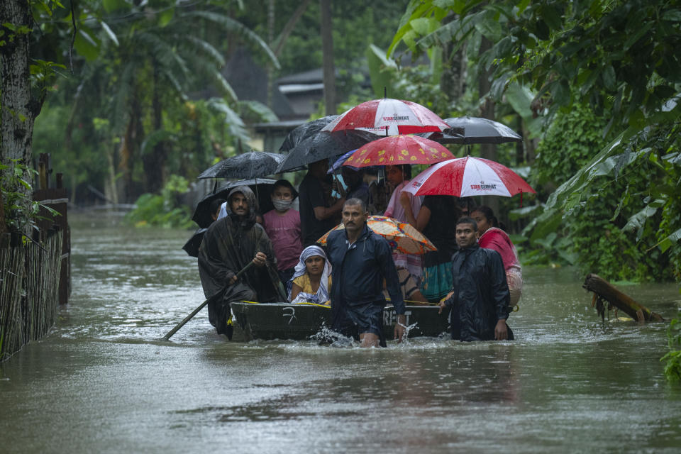 Indian army personnel rescue flood-affected villagers on a boat in Jalimura village, west of Gauhati, India, Saturday, June 18, 2022. (AP Photo/Anupam Nath)
