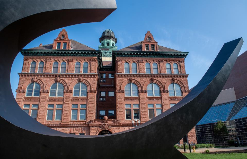 The seat of city government, Peoria City Hall, 419 Fulton St. in Downtown Peoria, is framed in the recently restored "Sonar Tide" sculpture. City Hall was built in 1899.