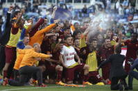 AS Roma's Francesco Totti (C) wears a t-shirt that reads "The Great Beauty" as he celebrates with his team mates at the end of the match against Lazio in their Serie A soccer match at the Olympic stadium in Rome, Italy, May 25, 2015. REUTERS/Alessandro Bianchi TPX IMAGES OF THE DAY