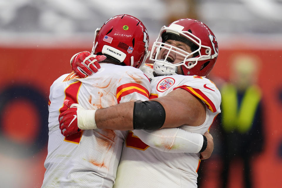 Kansas City Chiefs quarterback Chad Henne, left, celebrates with offensive guard Nick Allegretti after scoring a touchdown during the second half of an NFL football game against the Denver Broncos, Sunday, Oct. 25, 2020, in Denver. (AP Photo/David Zalubowski)