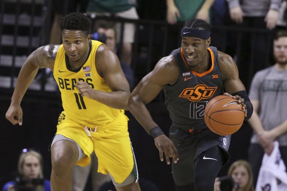 Oklahoma State forward Cameron McGriff, right, heads upcourt past Baylor guard Mark Vital, left, after a turnover during the first half of an NCAA college basketball game Saturday, Feb. 8, 2020, in Waco, Texas. (AP Photo/Rod Aydelotte)