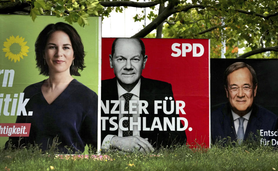 FILE - In This Thursday, Sept. 16, 2021 file photo, three elections posters show top candidate for chancellor of the Greens Annalena Baerbock, left, Social Democratic top candidate for chancellor Olaf Scholz, center, and Christian Democratic top candidate for chancellor Armin Laschet, right, in Berlin, Germany. Germany's election campaign has largely focused on the three candidates hoping to succeed Angela Merkel as chancellor after four terms in office. German federal elections will be on Sept. 26, 2021. (AP Photo/Michael Sohn, file)