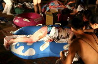 Injured victims from an accidental explosion during a music concert lie on the ground at the Formosa Water Park in New Taipei City, Taiwan, June 27, 2015. REUTERS/Chen Bo