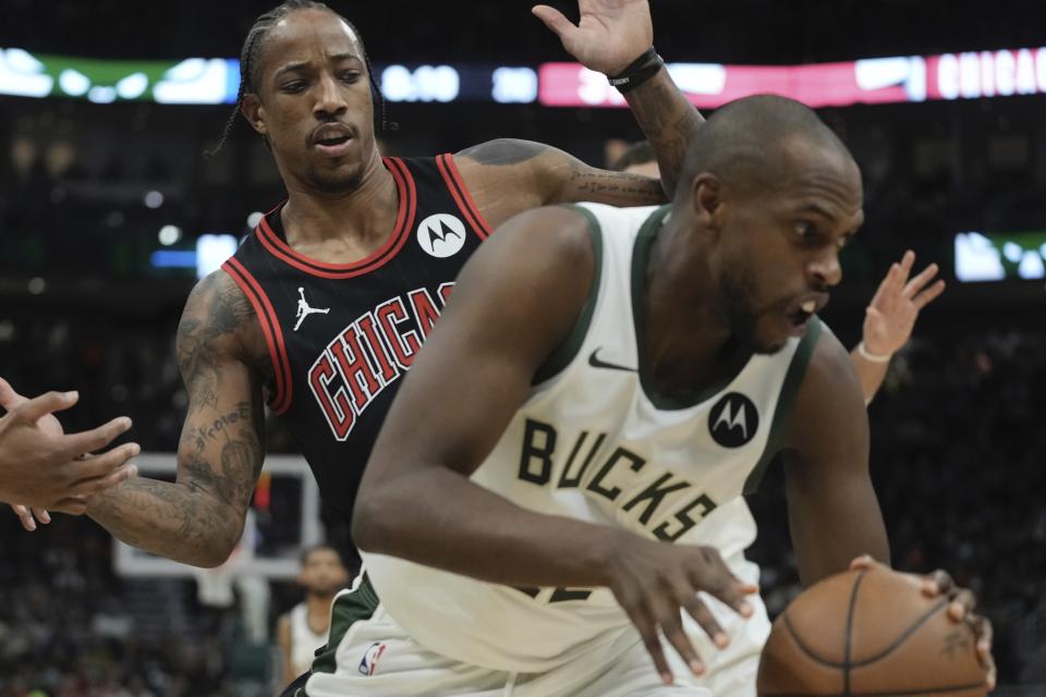 Milwaukee Bucks' Khris Middleton gets a loose ball in front of Chicago Bulls' DeMar DeRozan during the first half of an NBA basketball game Monday, Nov. 13, 2023, in Milwaukee. (AP Photo/Morry Gash)