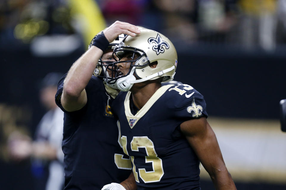 New Orleans Saints wide receiver Michael Thomas (13) is congratulated by quarterback Drew Brees after the two connected on a touchdown reception in the first half of an NFL football game against the Indianapolis Colts in New Orleans, Monday, Dec. 16, 2019. (AP Photo/Butch Dill)