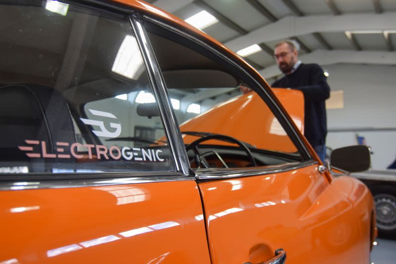 Steve Drummond, co-founder of Electrogenic opens up the hood of a converted Volkswagen Karmann Ghia, in Kidlington