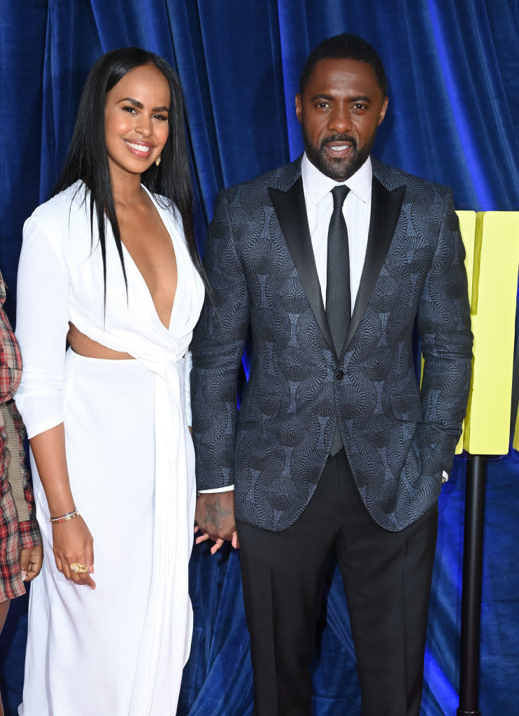 idris is with his wife and he is wearing a suit