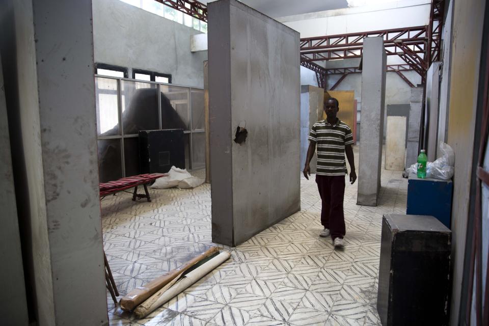 In this July 4, 2019 photo, Clautaire Leveille walks inside the earthquake damaged Musée d'Art du Collège Saint Pierre, in Port-au-Prince, Haiti. The 2010 quake also devastated other museums and galleries across Haiti, with $30 million in losses reported at the Musée Galerie d'Art Nader, which had had one of the world's most extensive collections of Haitian art. (AP Photo/Dieu Nalio Chery)