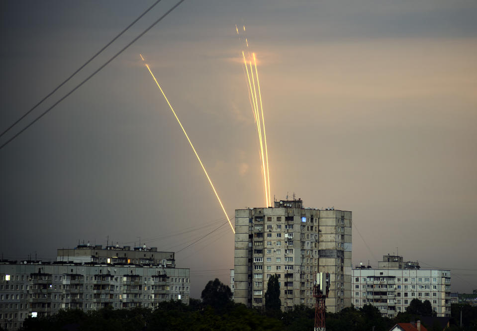 FILE - Russian rockets are launched against Ukraine from Russia's Belgorod region at dawn in Kharkiv, Ukraine, Aug. 15, 2022. Eight months after Russian President Vladimir Putin launched an invasion against Ukraine expecting a lightening victory, the war continues, affecting not just Ukraine but also exacerbating death and tension in Russia among its own citizens. (AP Photo/Vadim Belikov, File)