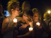 <p>Mona Rodriguez holds her 12-year-old son, J Anthony Hernandez, during a candlelight vigil held for the victims of a fatal shooting at the First Baptist Church of Sutherland Springs, Sunday, Nov. 5, 2017, in Sutherland Springs, Texas. (Photo: Nick Wagner/Austin American-Statesman via AP) </p>