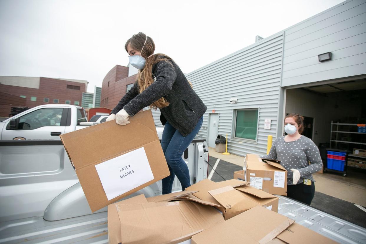 Cassy White, who recently quit as director of the Health Equity, Epidemiology and Data Unit of the St. Joseph County Health Department, loads donated medical supplies in March 2020 at Ivy Tech Community College in South Bend.