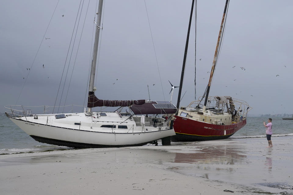 Boats sit on the beach in the aftermath of Tropical Storm Eta, Thursday, Nov. 12, 2020, in Gulfport, Fla. Eta dumped torrents of blustery rain on Florida's west coast as it slogged over the state before making landfall near Cedar Key, Fla. (AP Photo/Lynne Sladky)