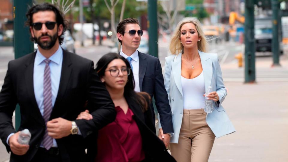 PHOTO: The son, left, and daughter, back right, of Pittsburgh dentist Lawrence 'Larry' Rudolph head into federal court for the afternoon session of the trial, July 13, 2022, in Denver.  (David Zalubowski/AP, File)