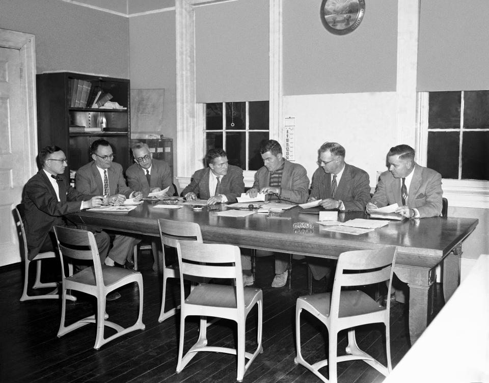 The Hillsboro City Board of Education is shown in session, April 9, 1956 as it decided not to oppose further a U.S. Court of Appeals decision which directed immediate racial integration of elementary schools. The appeals court decision reversed a previous decision of U.S. District Judge John H. Druffel, Cincinnati. The board tonight also decided to again refer the case to Judge Druffel, who is awaiting a writ of the appeals court decision.  From left to right: City Solicitor James O. Hapner, Wilfred Paul, school superintendent Paul L. Upp; Elmer Hedges, Dr. William Lukens, board president; Charles Harsha, and John H. Brown. (AP Photo/Harvey Eugene Smith)