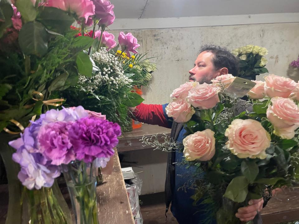 McKenna's Flower Shop owner Michael Rankowitz gets flowers for a customer.