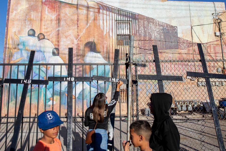 The number 148 is written on crosses representing the number of dead migrants during the year 2023 in the El Paso Border Sector during a remembrance of dead migrants held by Border Network for Human Rights on Nov. 2, 2023. A few days after the memorial Border Patrol raised the number of dead to 149.