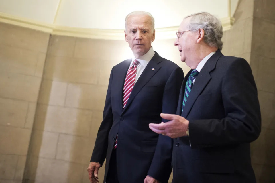 Then-Vice President Joe Biden and Then-Senate Majority Leader Mitch McConnell make their way to the House floor for President Obama&#39;s State of the Union address on January 12, 2016. (Photo By Tom Williams/CQ Roll Call)