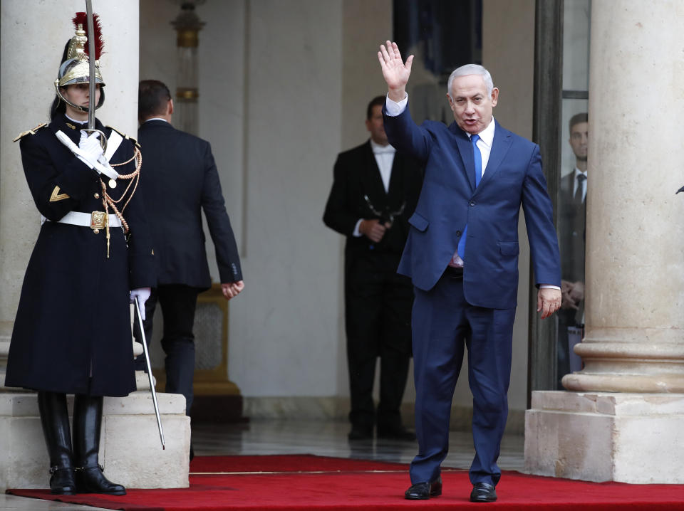 Israeli Prime Minister Benjamin Netanyahu waves as he arrives at the Elysee Palace in Paris for a lunch after participating in a World War I Commemoration Ceremony, Sunday Nov. 11, 2018. International leaders are taking place in a ceremony in Paris on Sunday to mark the 100th anniversary of the Armistice that ended World War I. (AP Photo/Christophe Ena)