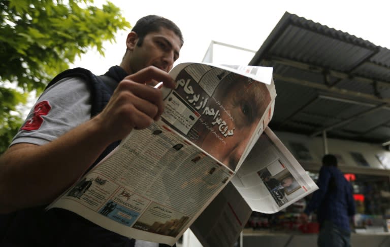 An Iranian man checks a newspaper in Tehran on May 9, 2018 a day after the US pulled out of the nuclear deal