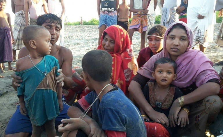 Surviving Myanmar refugees cry after a boat accident killed at least 10 Rohingya, all women and children, next to the Bangladeshi shoreline in Teknaf on October 16, 2017