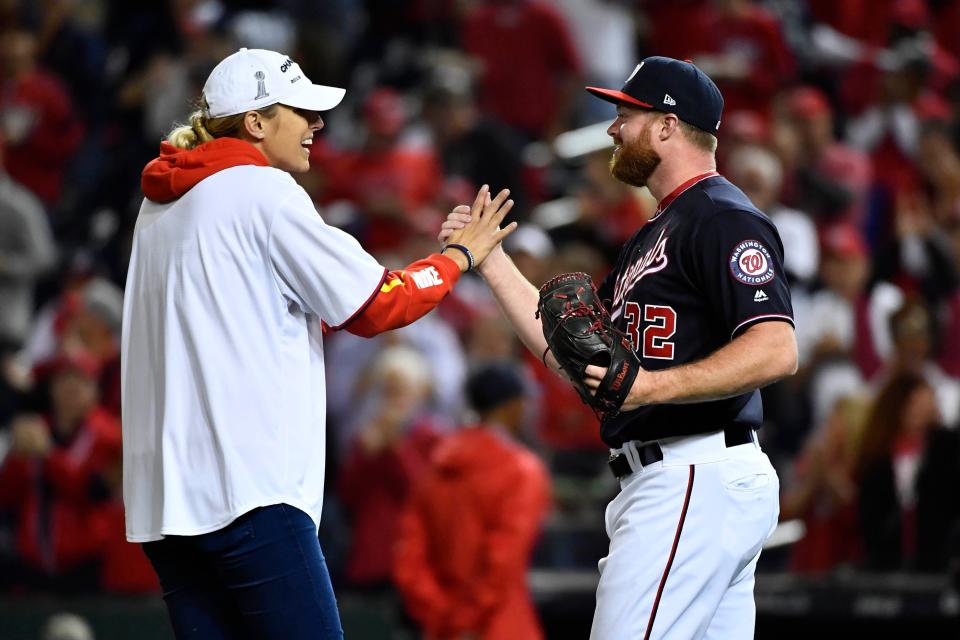 Washington Mystics forward Elena Delle Donne greets Washington Nationals pitcher Aaron Barrett (32) before game four of the 2019 NLCS playoff baseball series between the St. Louis Cardinals and the Washington Nationals at Nationals Park on Tuesday, Oct. 15, 2019 in Washington.