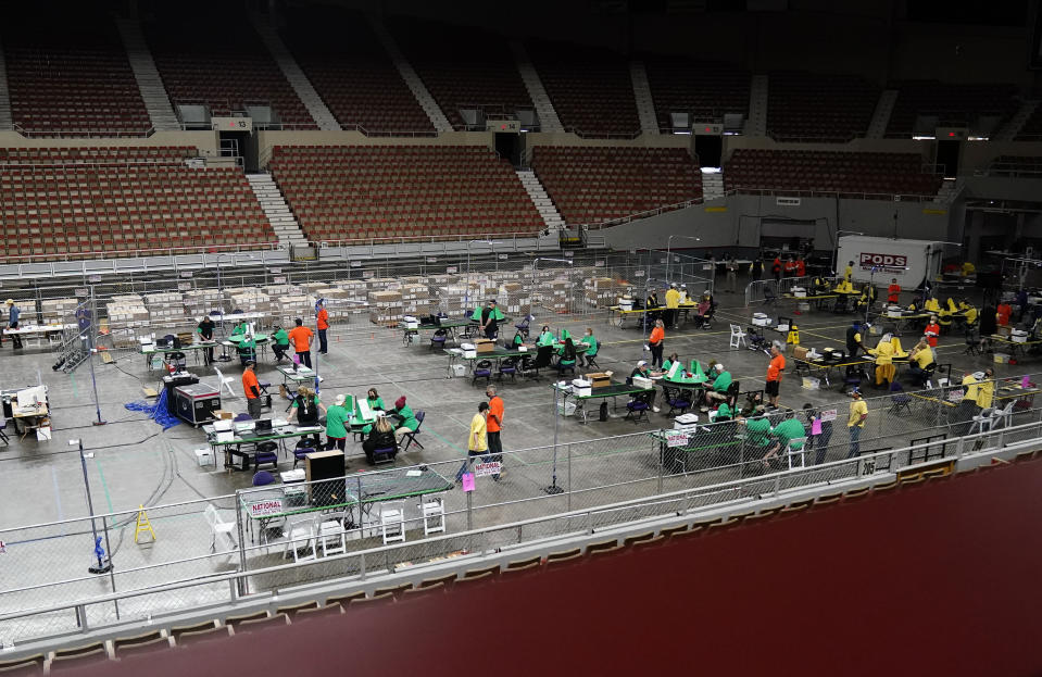 Maricopa County ballots cast in the 2020 general election are being examined and recounted by contractors working for Florida-based company, Cyber Ninjas, who was hired by the Arizona State Senate at Veterans Memorial Coliseum in Phoenix, Thursday, April 29, 2021. (Rob Schumacher/The Arizona Republic via AP, Pool)