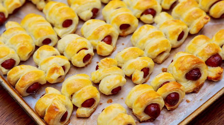 Glazed pigs in blankets on baking tray