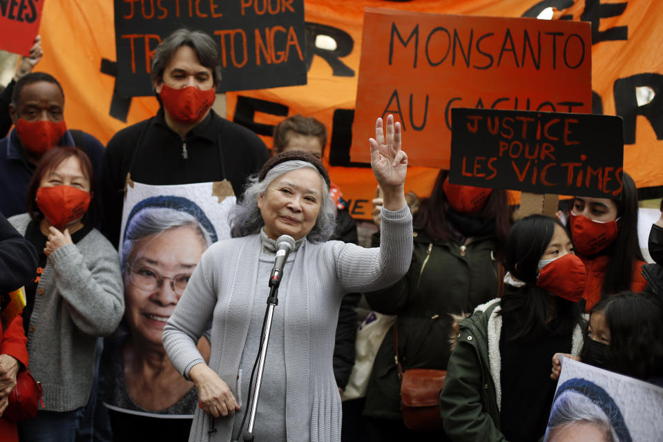 Tran To Nga, a 78-year-old former journalist, waves as she delivers a speech during a gathering in support of people exposed to Agent Orange during the Vietnam War, in Paris, Saturday Jan. 30, 2021. Activists gathered Saturday in Paris in support of people exposed to Agent Orange during the Vietnam War, after a French court examined a case opposing a French-Vietnamese woman to 14 companies that produced and sold the toxic chemical. (AP Photo/Thibault Camus)