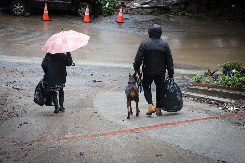 Feb 6, 2024; Studio City, Calif., USA; Homeowners evacuate their homes in Studio City where a large mud slide destroyed multiple homes in the area. A powerful atmospheric river storm deluged California on Monday with more heavy rain, mudslides, flooding and several feet of snow in the mountains. The brunt of Monday's storms centered on the Los Angeles area, where 1.4 million people were under a flash flood warning – including the Hollywood Hills and Beverly Hills. Additional rainfall totals of 5-8 inches were forecast in some areas, which would bring 48-hour totals as high as 14 inches for some locations, the weather service said. A state of emergency was declared in eight Southern California counties. Mandatory Credit: Yannick Peterhans-USA TODAY ORG XMIT: USAT-749889 ORIG FILE ID: 20240206_aa9_usa_004.JPG