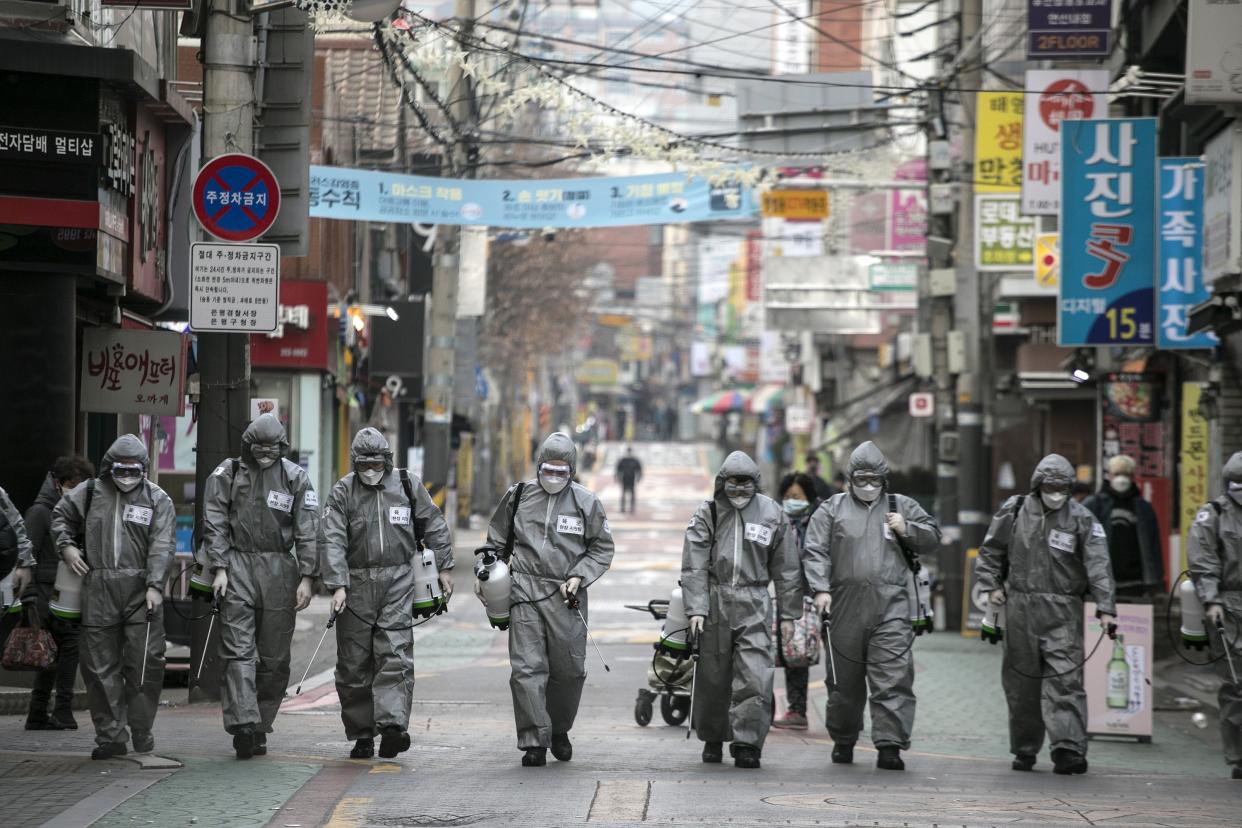 South Korean soldiers in protective gear disinfect the Eunpyeong district against the coronavirus (COVID-19) on March 4 in Seoul. The South Korean government raised the coronavirus alert to the "highest level" as cases rise.