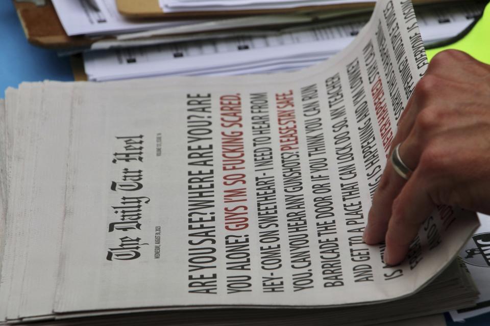 A man picks up a copy of The Daily Tar Heel, the student newspaper at University of North Carolina at Chapel Hill, Wednesday, Aug. 30, 2023, in Chapel Hill, N.C. An image of the front page, which features text messages sent and received by students during a shooting on campus, has gone viral on social media. (AP Photo/Hannah Schoenbaum)