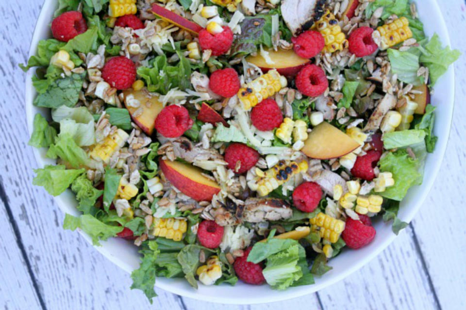 <p>Here, fresh peaches, raspberries and a little cheese are topped on a bed of fresh greens and finished with grilled chicken and corn plus Balsamic dressing.</p><p>Recipe here: <strong><a href="http://www.recipegirl.com/2015/06/23/grilled-chicken-summer-salad-with-balsamic-vinaigrette/" rel="nofollow noopener" target="_blank" data-ylk="slk:Grilled Chicken Summer Salad;elm:context_link;itc:0;sec:content-canvas" class="link ">Grilled Chicken Summer Salad</a></strong></p>