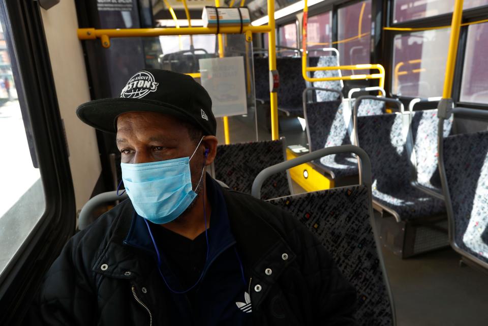 Albert Dowdell, wears a protective mask on a bus during the COVID-19 outbreak in Detroit, Wednesday, April 8, 2020. Detroit buses will have surgical masks available to riders starting Wednesday, a new precaution the city is taking from the new coronavirus. (AP Photo/Paul Sancya) ORG XMIT: MIPS102